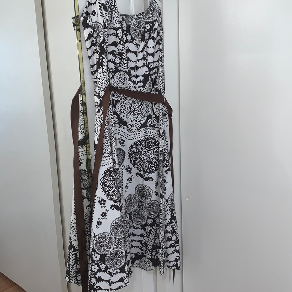 White and brown dress with floral pattern.